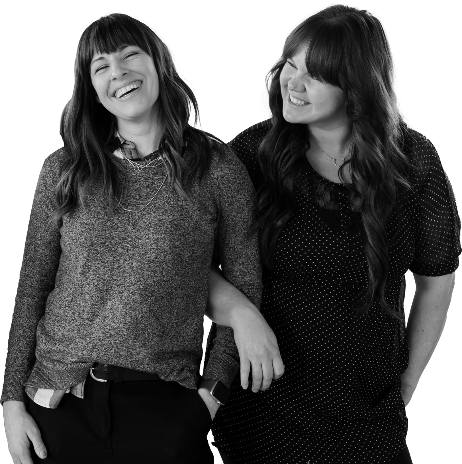 two women link arms to show their support of each other. They have long hair, and the picture is in black and white.